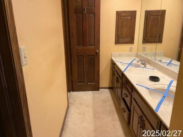 bathroom with baseboards and a sink