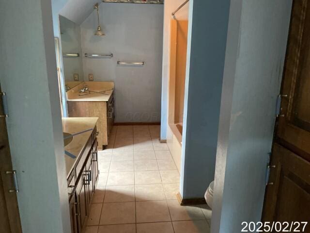 full bathroom featuring tile patterned flooring, vanity, toilet, and baseboards