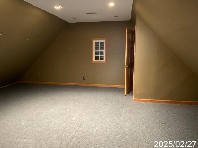 additional living space with vaulted ceiling, carpet floors, baseboards, and recessed lighting