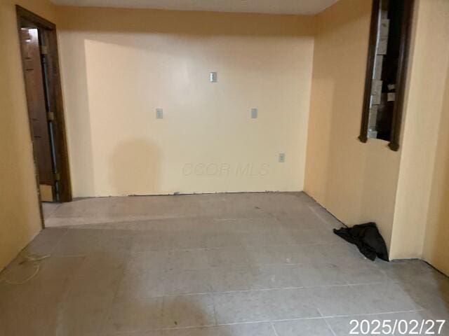spare room with tile patterned flooring
