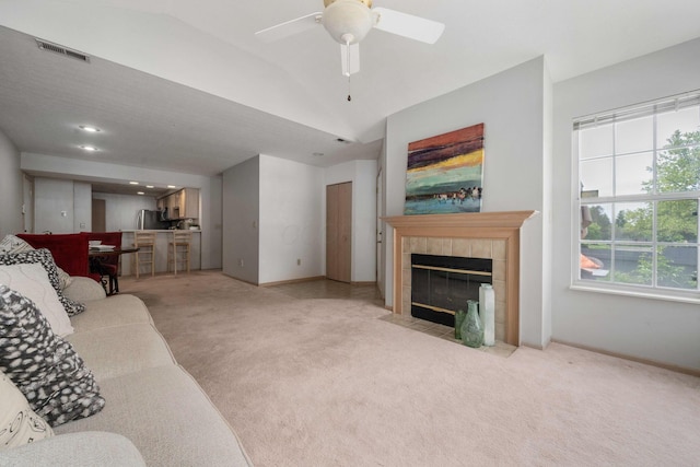1272 Villa Oaks Ct, Columbus, OH 43230 - carpeted living room featuring a tiled fireplace, ceiling fan, baseboards, and vaulted ceiling