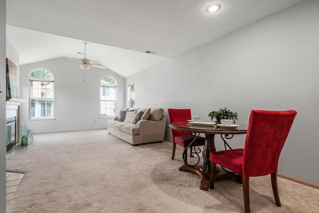1272 Villa Oaks Ct, Columbus, OH 43230 - carpeted living room with ceiling fan, vaulted ceiling, baseboards, a fireplace with flush hearth, and a textured ceiling