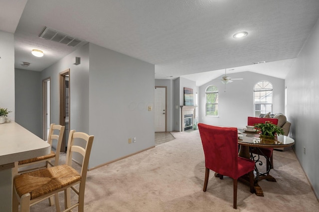 1272 Villa Oaks Ct, Columbus, OH 43230 - dining room featuring light colored carpet, a ceiling fan, a fireplace, lofted ceiling, and baseboards