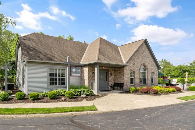 1272 Villa Oaks Ct, Columbus, OH 43230 - view of front of house featuring fence, roof with shingles, and brick siding