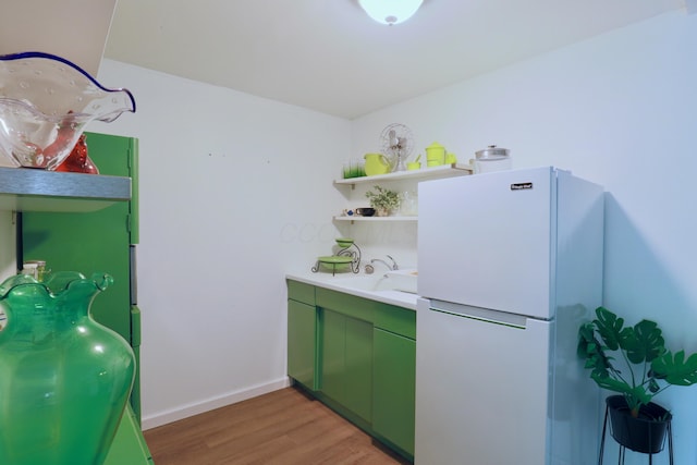 2215 Township Road 362 SE, Junction City, OH 43748 - kitchen featuring freestanding refrigerator, green cabinets, light wood-style flooring, open shelves, and a sink