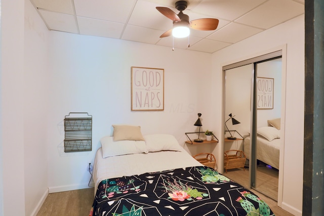 2215 Township Road 362 SE, Junction City, OH 43748 - bedroom featuring a drop ceiling, a closet, wood finished floors, baseboards, and a ceiling fan