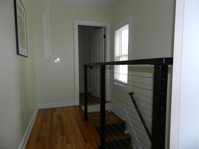 236 E 4th Ave, Columbus, OH 43201 - hallway featuring wood finished floors, baseboards, and an upstairs landing