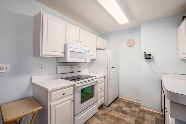 2412 Warm Springs Dr, Hilliard, OH 43026 - kitchen featuring white appliances, white cabinetry, light countertops, stone finish floors, and baseboards