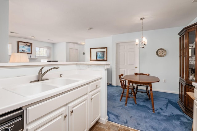 2412 Warm Springs Dr, Hilliard, OH 43026 - kitchen with a sink, light countertops, white cabinetry, and pendant lighting