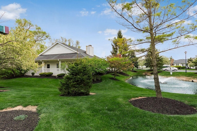 2412 Warm Springs Dr, Hilliard, OH 43026 - view of green lawn with covered porch and a water view