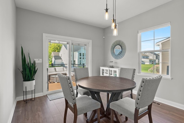 dining area featuring wood finished floors and baseboards