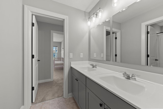 bathroom featuring double vanity and baseboards