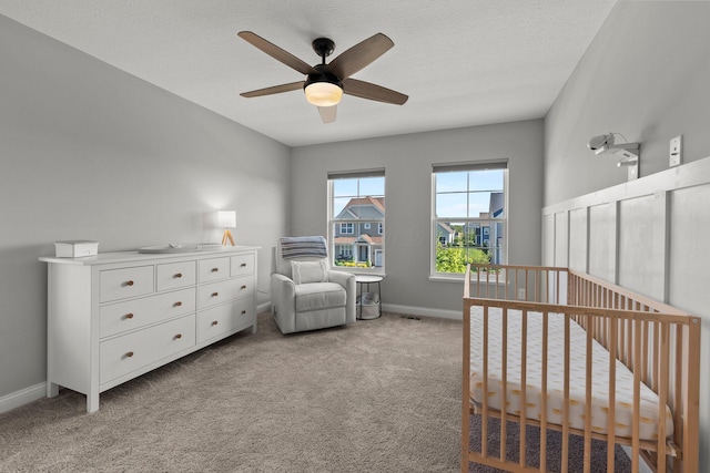 living area featuring carpet floors, a ceiling fan, and baseboards