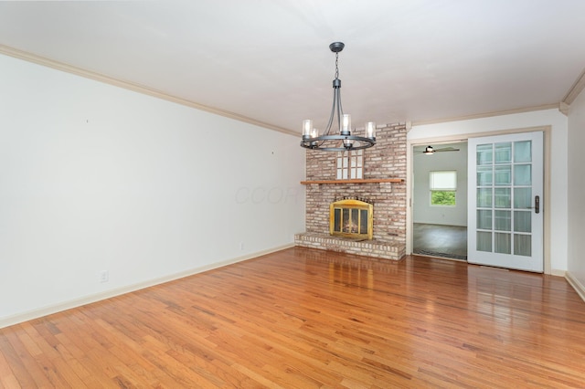 26976 Jackson Rd, Circleville, OH 43113 - unfurnished living room featuring a chandelier, light wood-type flooring, crown molding, baseboards, and ceiling fan