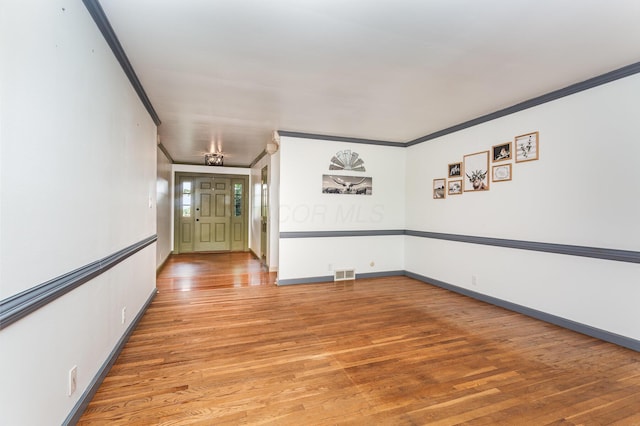26976 Jackson Rd, Circleville, OH 43113 - spare room featuring ornamental molding, light wood-style flooring, and baseboards
