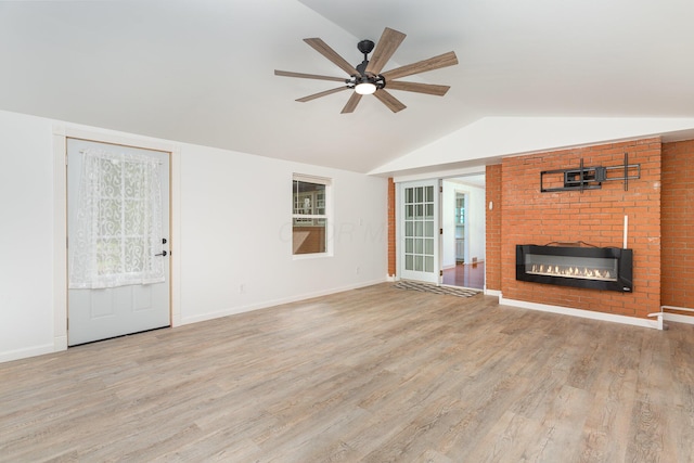 26976 Jackson Rd, Circleville, OH 43113 - unfurnished living room featuring a fireplace, vaulted ceiling, ceiling fan, wood finished floors, and baseboards