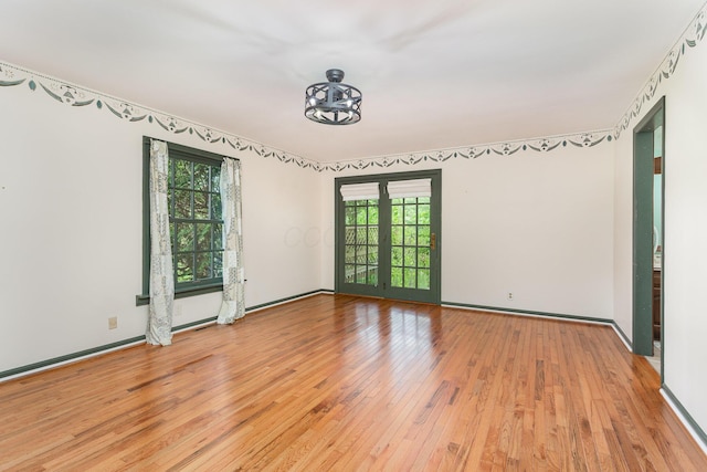 26976 Jackson Rd, Circleville, OH 43113 - unfurnished room featuring light wood-type flooring, a chandelier, and baseboards