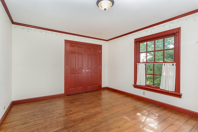 26976 Jackson Rd, Circleville, OH 43113 - empty room with wood-type flooring, baseboards, and ornamental molding