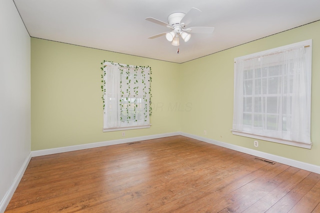 26976 Jackson Rd, Circleville, OH 43113 - spare room featuring wood finished floors, a ceiling fan, and baseboards