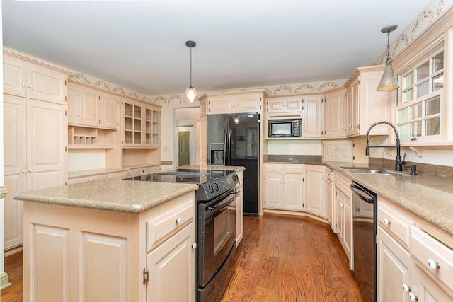 26976 Jackson Rd, Circleville, OH 43113 - kitchen with black appliances, a sink, a center island, and wood finished floors