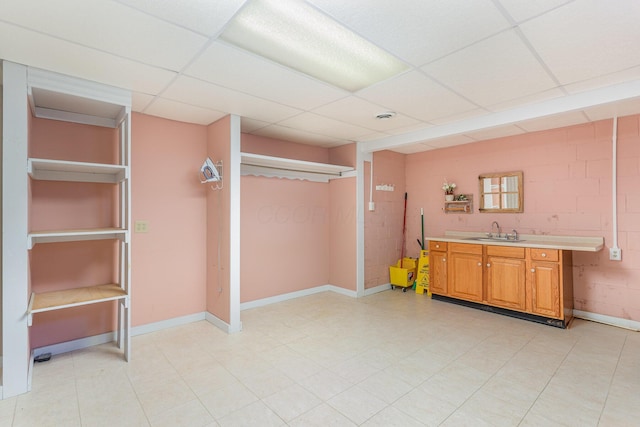 26976 Jackson Rd, Circleville, OH 43113 - finished below grade area featuring a sink, a paneled ceiling, concrete block wall, and baseboards