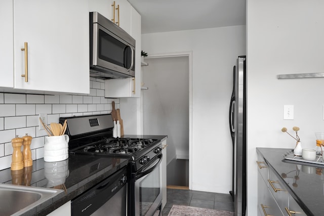 1809 NW Ct Unit E, Columbus, OH 43212 - kitchen with appliances with stainless steel finishes, dark countertops, tasteful backsplash, and white cabinets