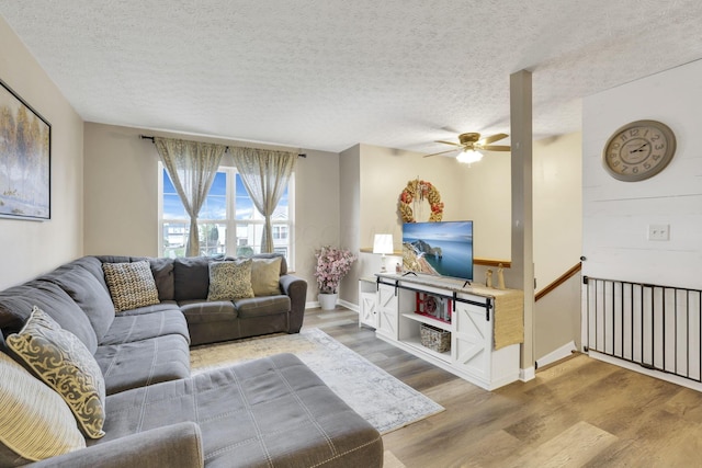 4292 Nipigon Dr, Columbus, OH 43207 - living room with wood finished floors, ceiling fan, a textured ceiling, and baseboards