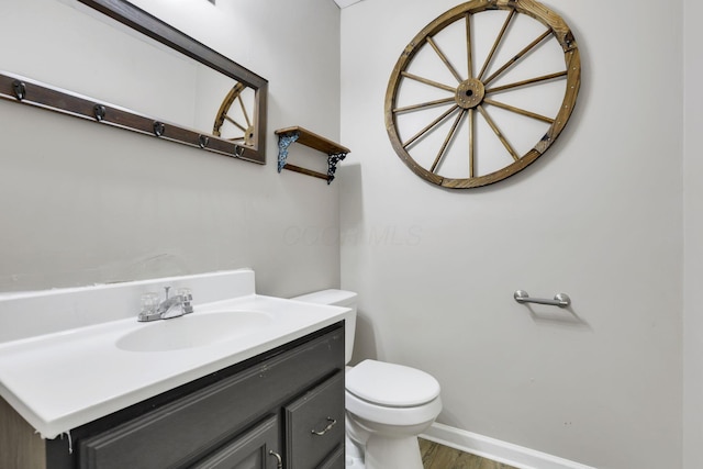 4292 Nipigon Dr, Columbus, OH 43207 - half bath with toilet, vanity, wood finished floors, and baseboards