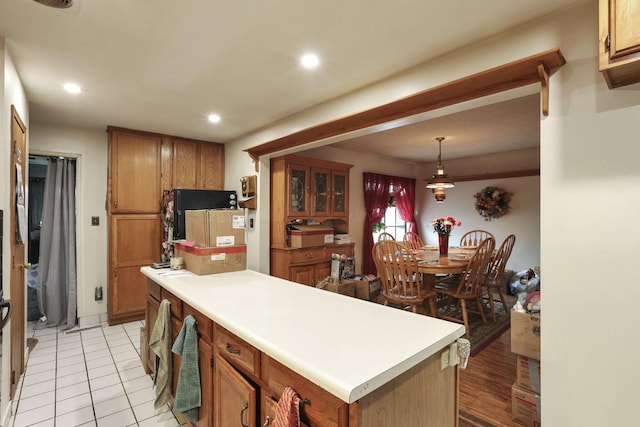 4969 Lockbourne Rd, Columbus, OH 43207 - kitchen with brown cabinetry, light countertops, recessed lighting, and light tile patterned flooring