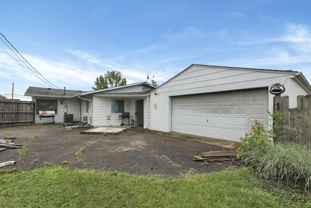4969 Lockbourne Rd, Columbus, OH 43207 - ranch-style home featuring an attached garage, central AC unit, and driveway