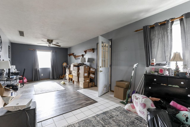 4969 Lockbourne Rd, Columbus, OH 43207 - bedroom with light tile patterned floors, ceiling fan, and a textured ceiling