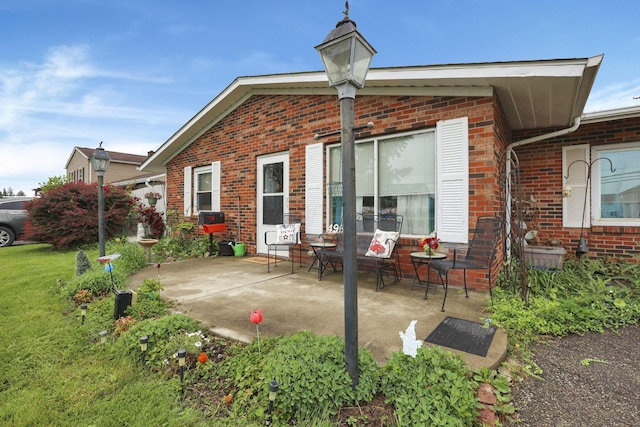 4969 Lockbourne Rd, Columbus, OH 43207 - back of house featuring brick siding, a patio, and a yard