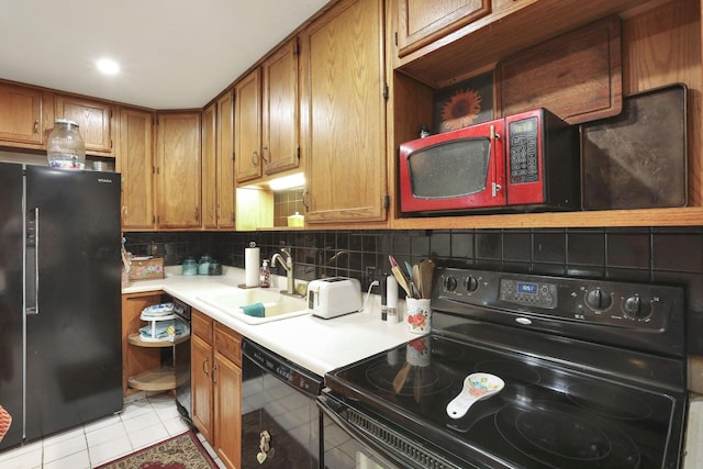 4969 Lockbourne Rd, Columbus, OH 43207 - kitchen featuring black appliances, a sink, light countertops, backsplash, and brown cabinetry