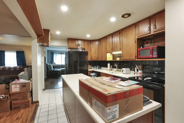 4969 Lockbourne Rd, Columbus, OH 43207 - kitchen featuring black appliances, a sink, decorative backsplash, light countertops, and recessed lighting