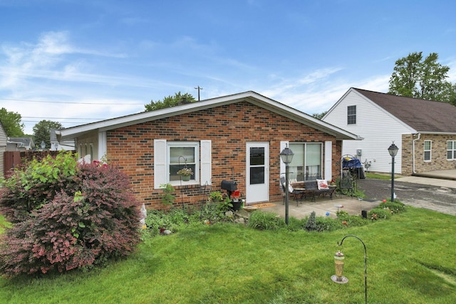 4969 Lockbourne Rd, Columbus, OH 43207 - view of front of property featuring brick siding, a front yard, and a patio