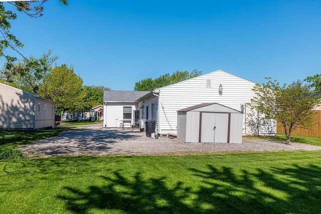 1150 Bahama Dr, Marion, OH 43302 - back of house with a storage unit, an outbuilding, and a yard