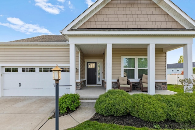 700 Ferguson Ave, Delaware, OH 43015 - entrance to property featuring a porch, an attached garage, concrete driveway, and stone siding