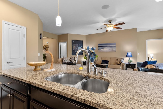 700 Ferguson Ave, Delaware, OH 43015 - kitchen with a sink, open floor plan, ceiling fan, and light stone counters