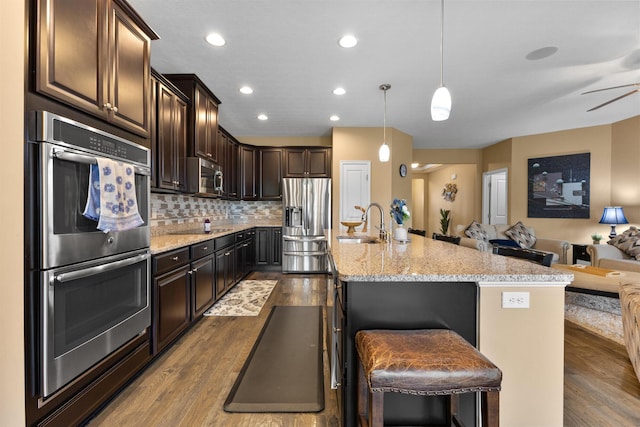 700 Ferguson Ave, Delaware, OH 43015 - kitchen with stainless steel appliances, open floor plan, dark wood-style floors, a sink, and dark brown cabinets