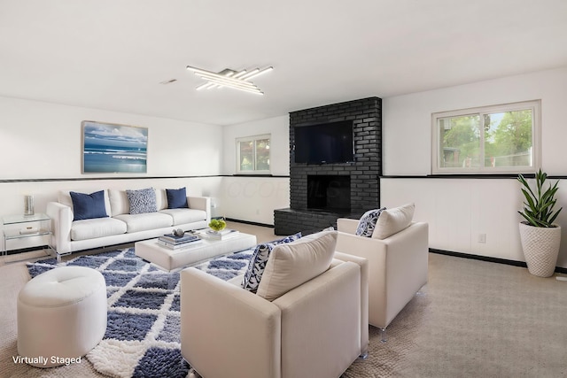 living room with a brick fireplace and light carpet