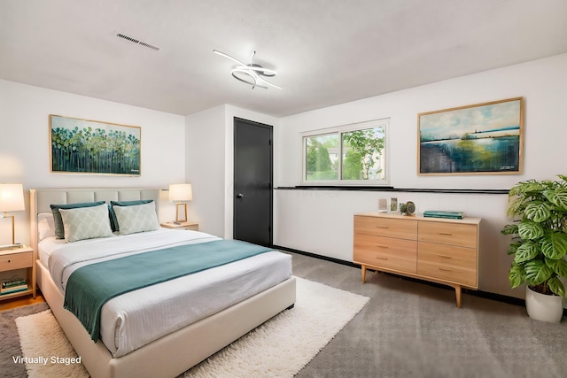 bedroom featuring light colored carpet