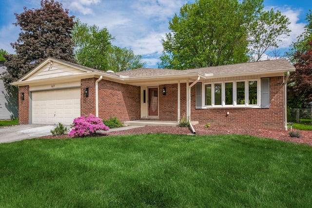 single story home featuring brick siding, a garage, and a front yard