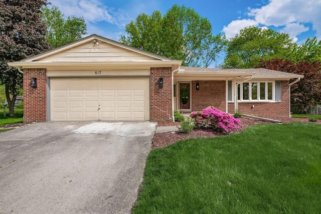 single story home featuring driveway, brick siding, an attached garage, and a front lawn