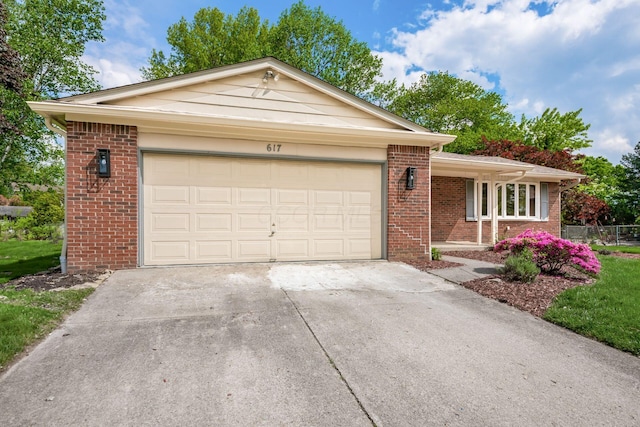 ranch-style home featuring driveway, brick siding, and a garage