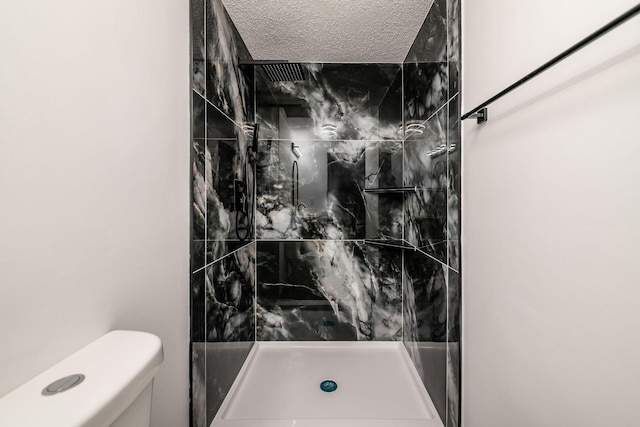 full bath with toilet and a stall shower