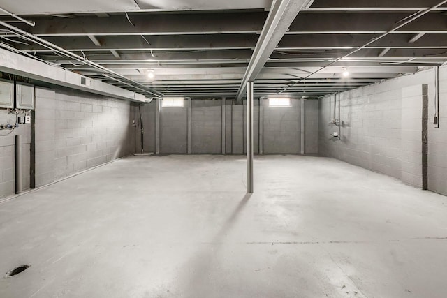 below grade area with electric panel and gas meter