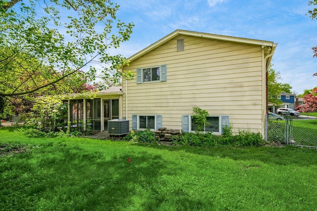 back of property featuring central AC unit and a sunroom