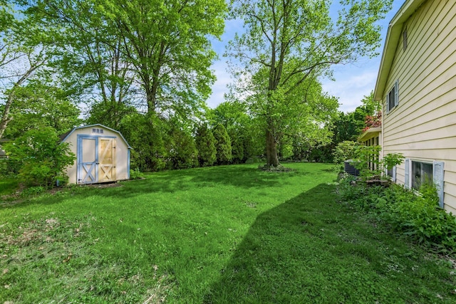 view of green lawn with a storage shed and an outdoor structure