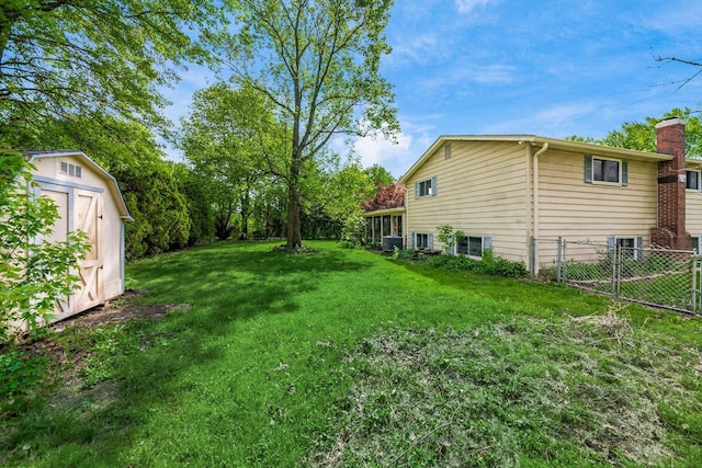 view of yard with a storage unit, an outdoor structure, and central AC