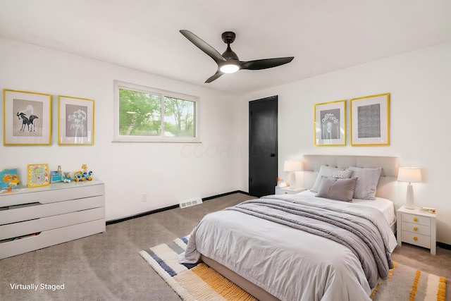carpeted bedroom featuring baseboards and ceiling fan